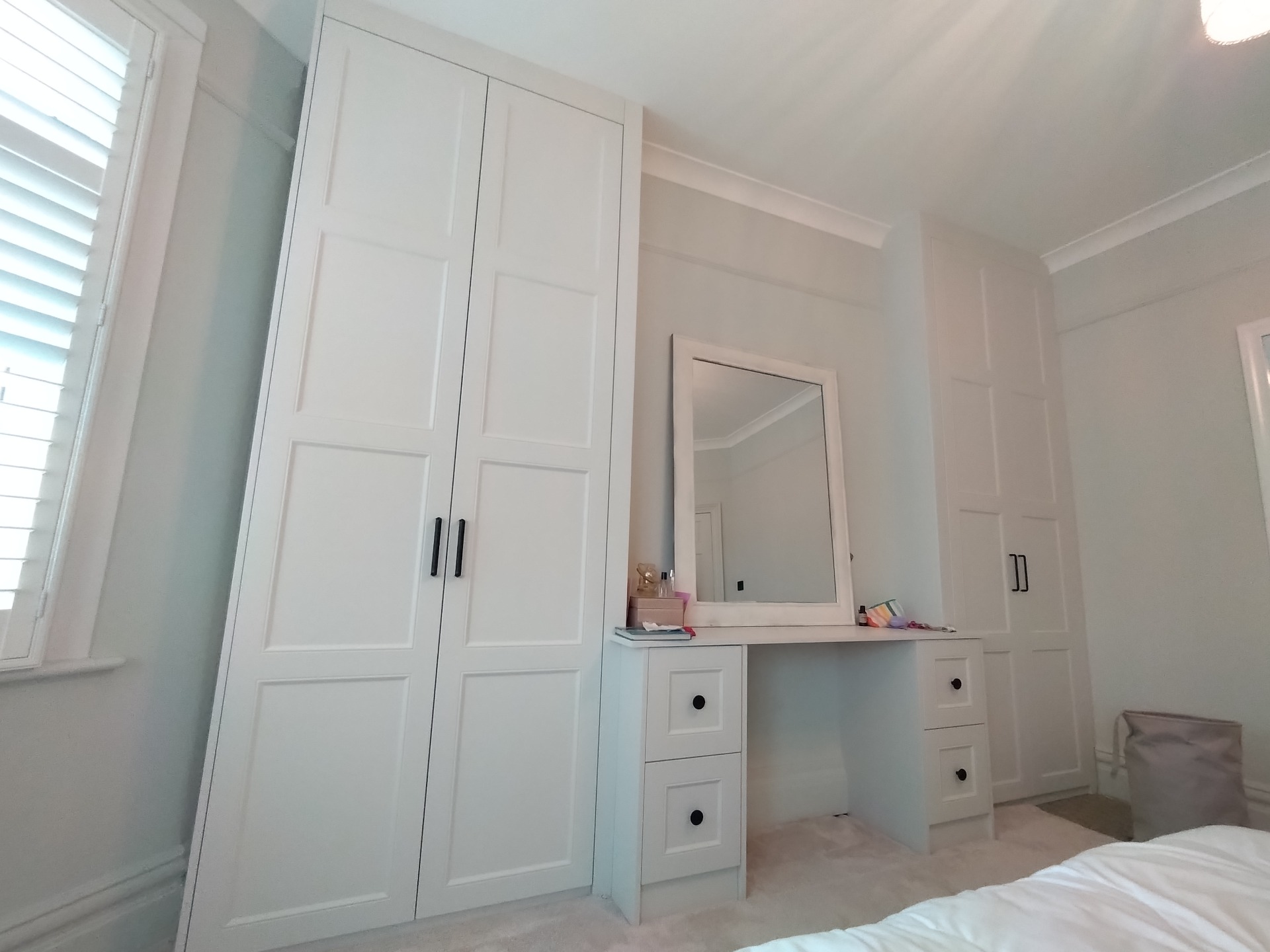 White shaker fitted wardrobes and dressing table