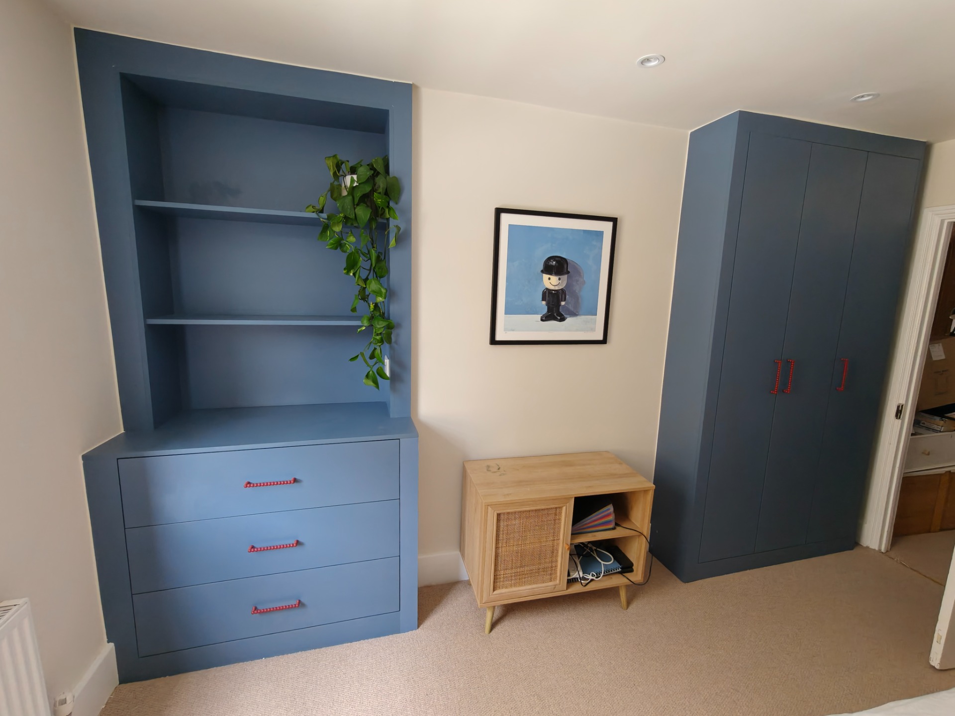 Blue alcove shelving with drawers and fitted wardrobe
