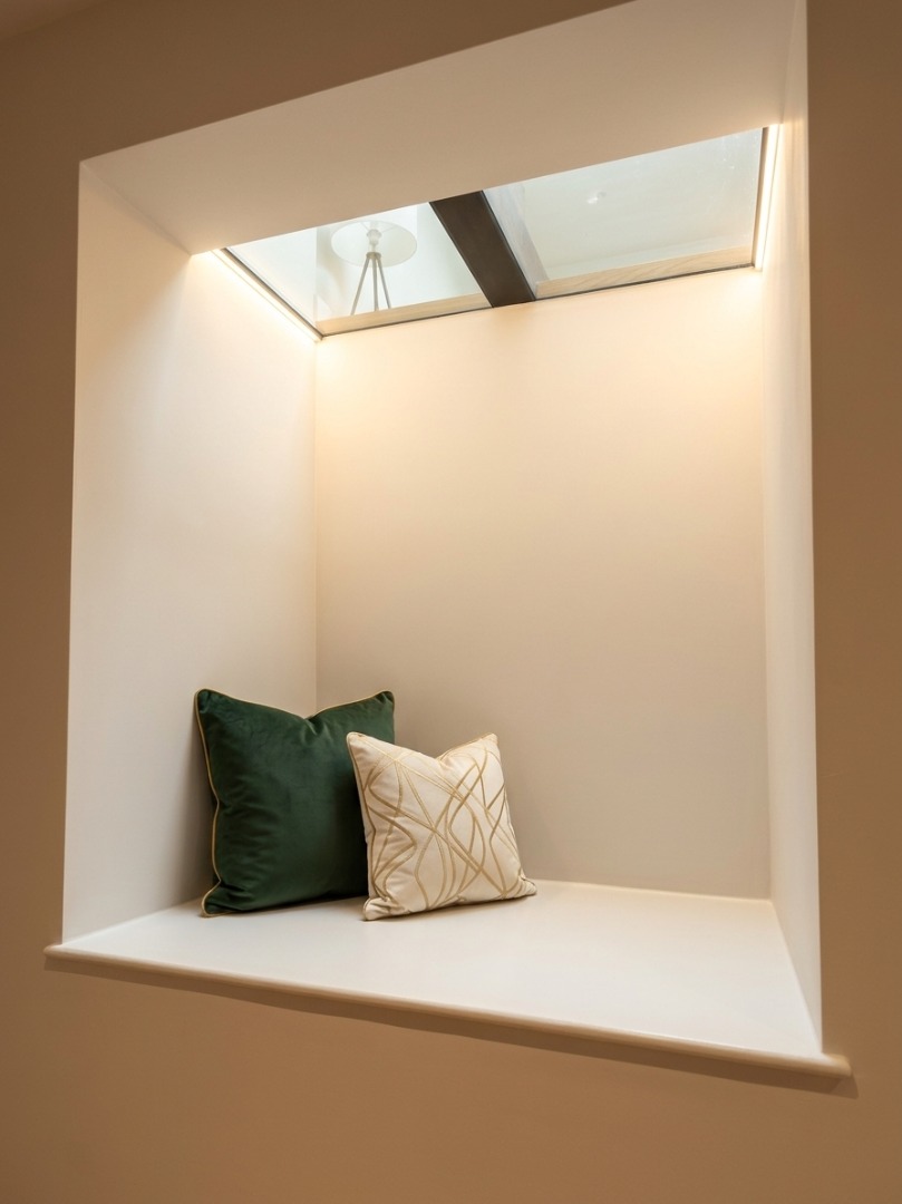 Alcove window seat beneath a skylight